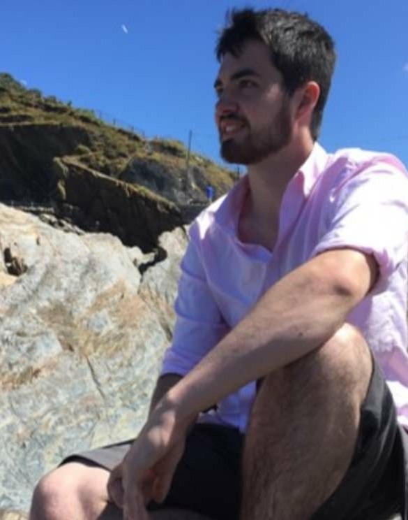 Michael Saunders sitting on a coastal rock outcrop
